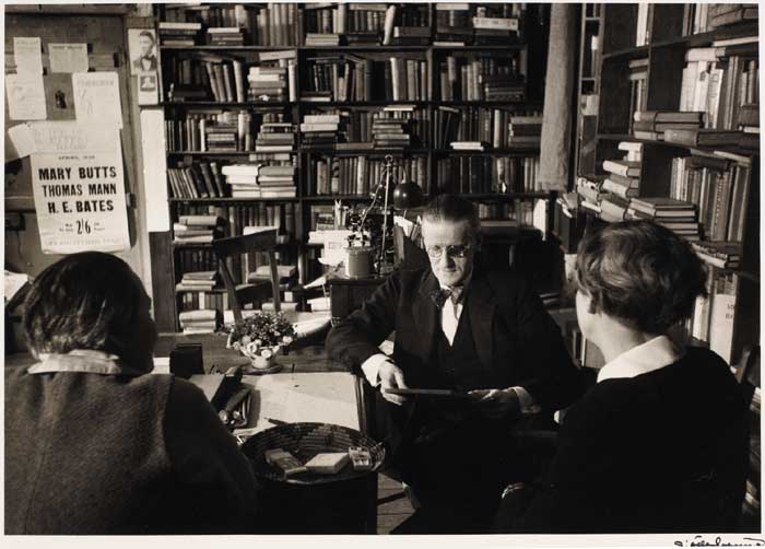 JAMES JOYCE WITH ADRIENNE MONNIER AND SYLVIA BEACH IN SHAKESPEARE AND CO. BOOKSHOP, MAY 1938 by Gisle Freund (German, 1908-2000) at Whyte's Auctions
