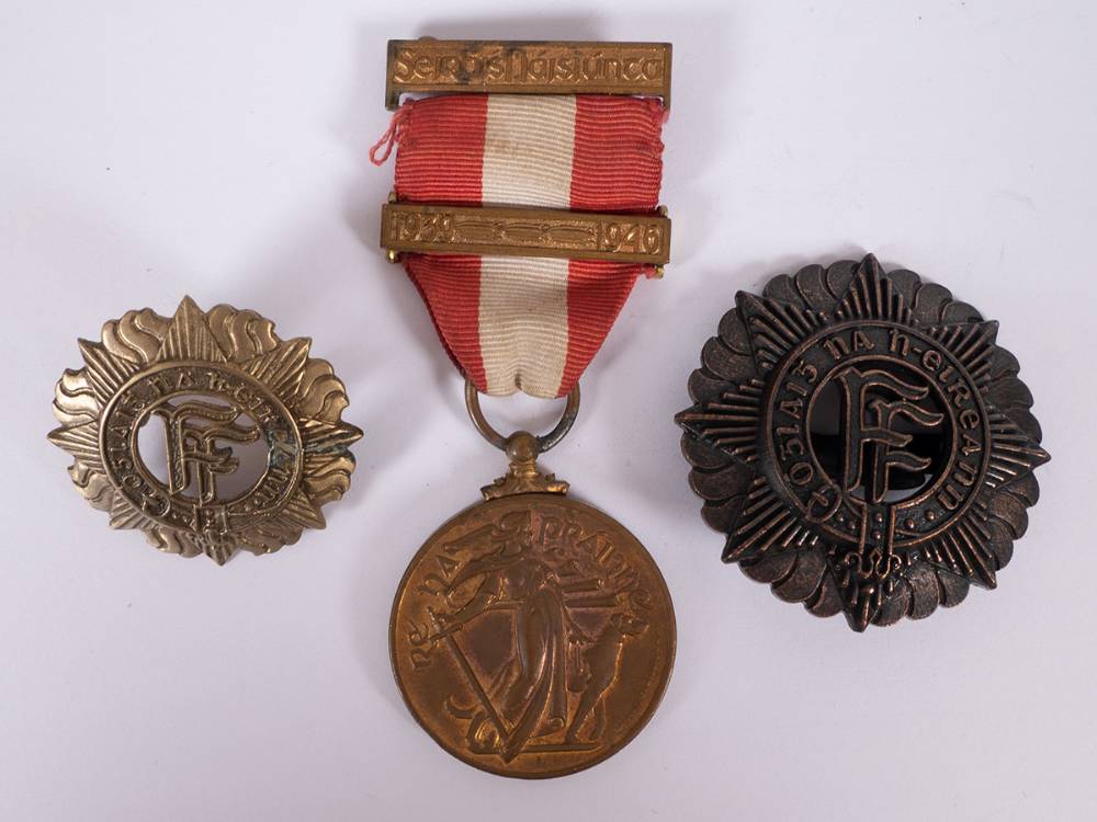 1930s Irish Army helmet badge, cap badge and 1939-46 Emergency Service Medal. at Whyte's Auctions