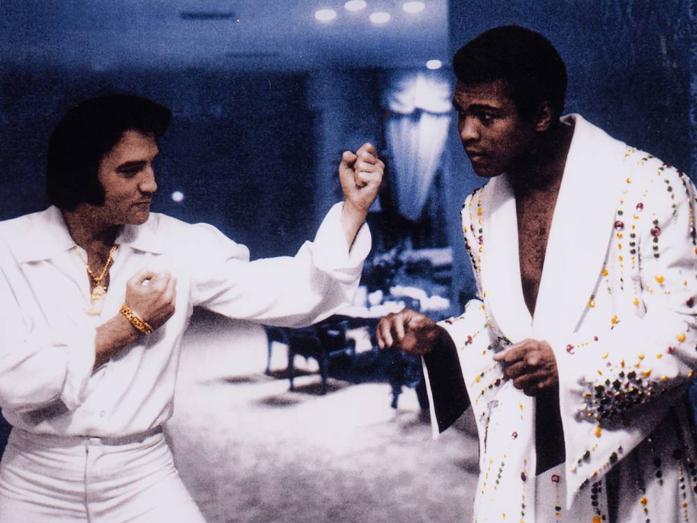 1973. Large colour photograph of Elvis Presley with Muhammad Ali, copy signatures engraved on white metal plaques. at Whyte's Auctions