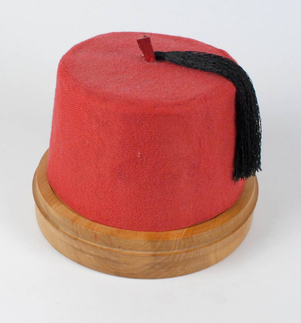 Circa 1975. Tommy Cooper autographed fez. at Whyte's Auctions
